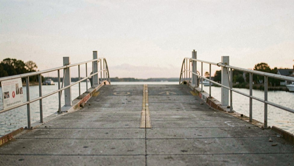 Empty boat launch ramp under pale morning sky